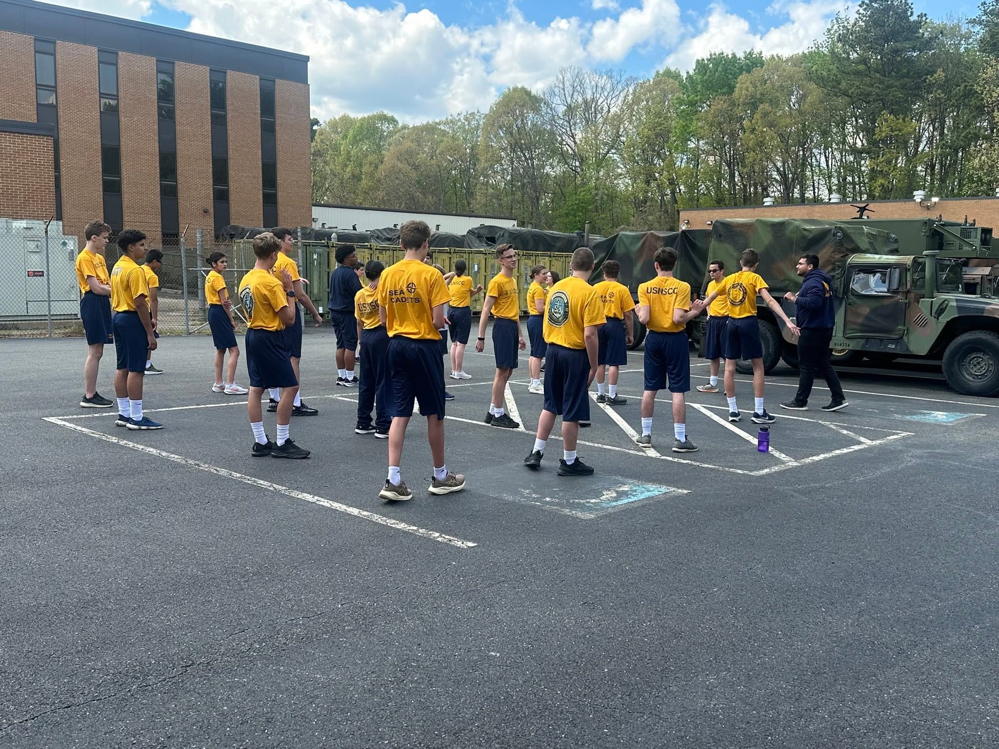 Cadets in PT gear outside with military Humvee in background