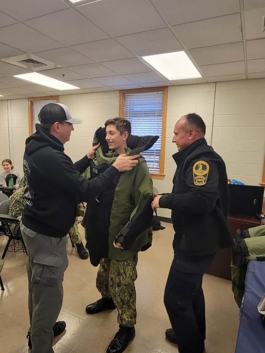 Virginia State Police helping a cadet into a bomb disposal suit